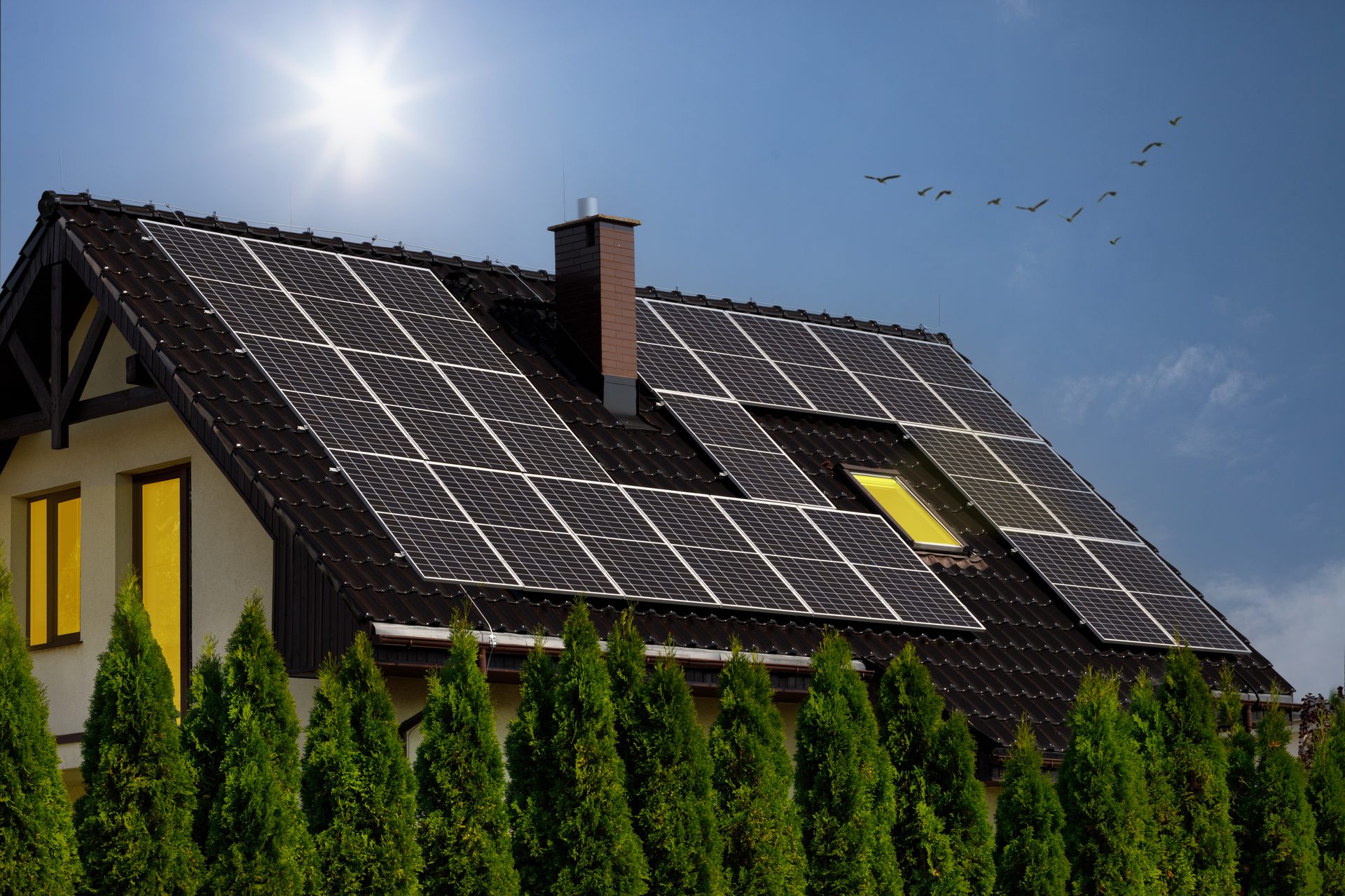 Home with rooftop solar panels under a bright sun